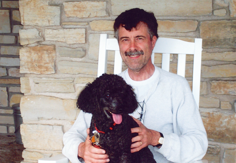 Picture of Allen McCaulley and Max the Dog on a white rocking chair on Door County, Wisconsin.